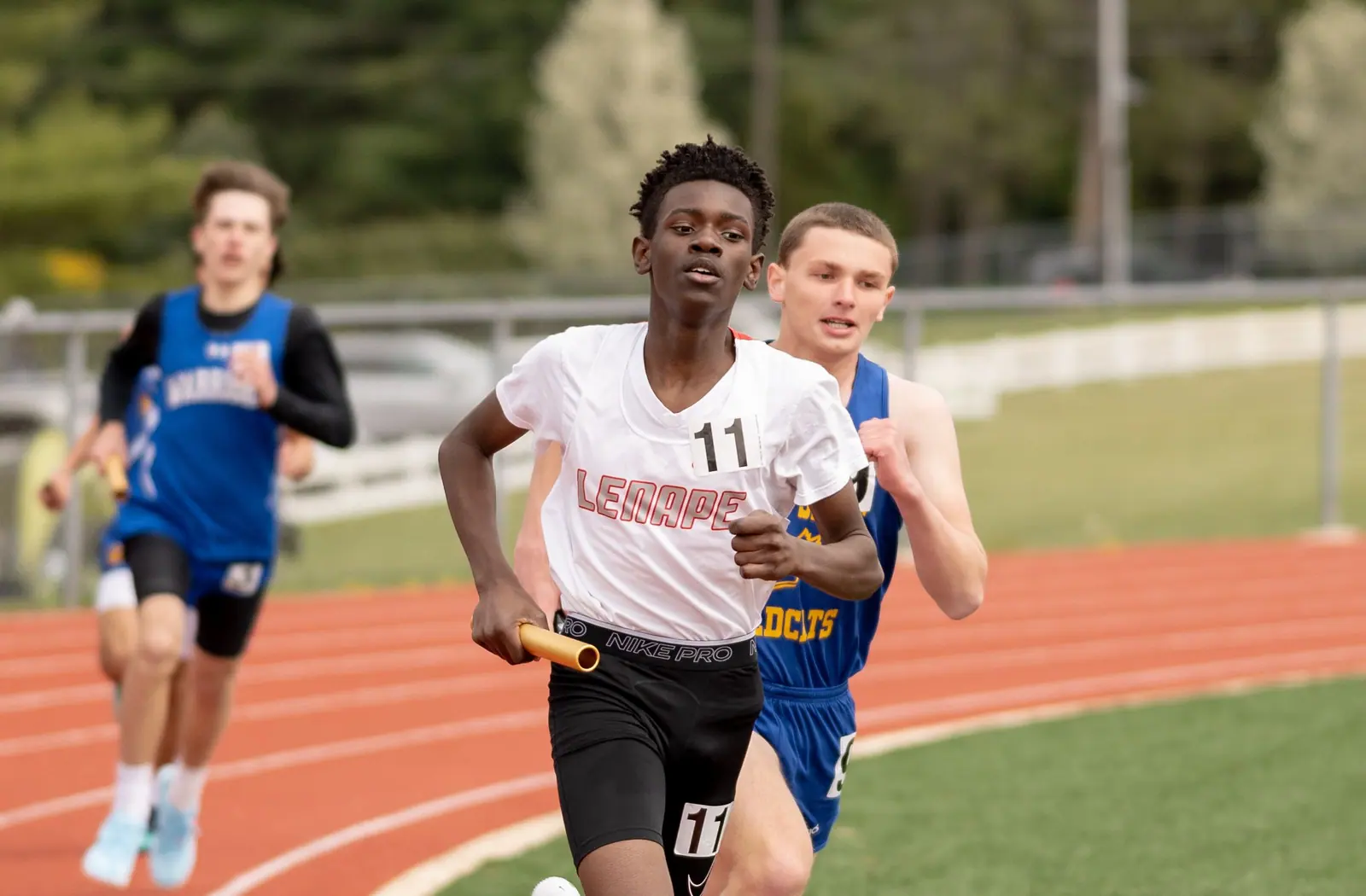 Teenage athletes competing in a relay race